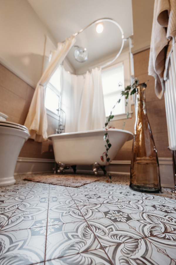 Patterned Floor Tile and Clawfoot Tub in Bathroom 