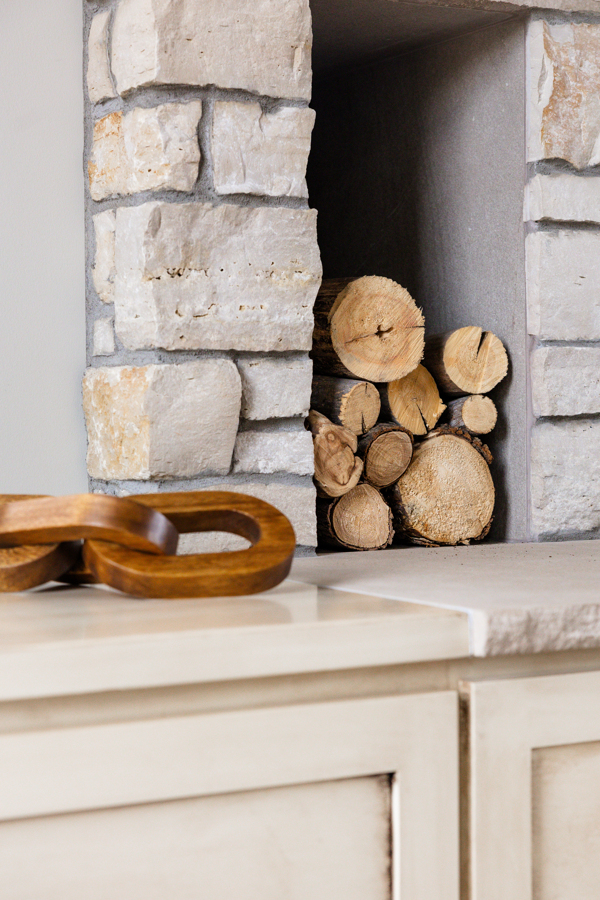 Brick Wood Burning Fireplace with custom stone hearth and built in drawers